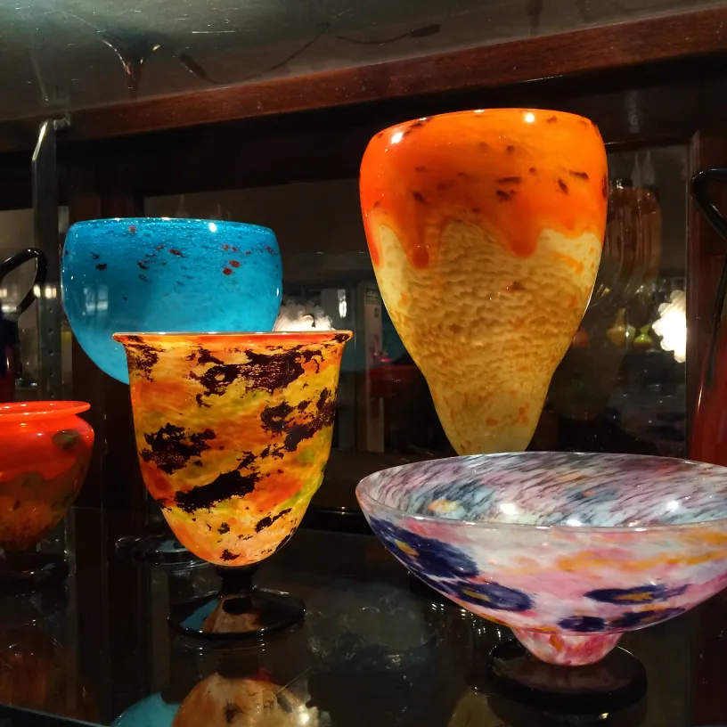 Collection of antiques featuring signed glass Schneider in various vivid colors