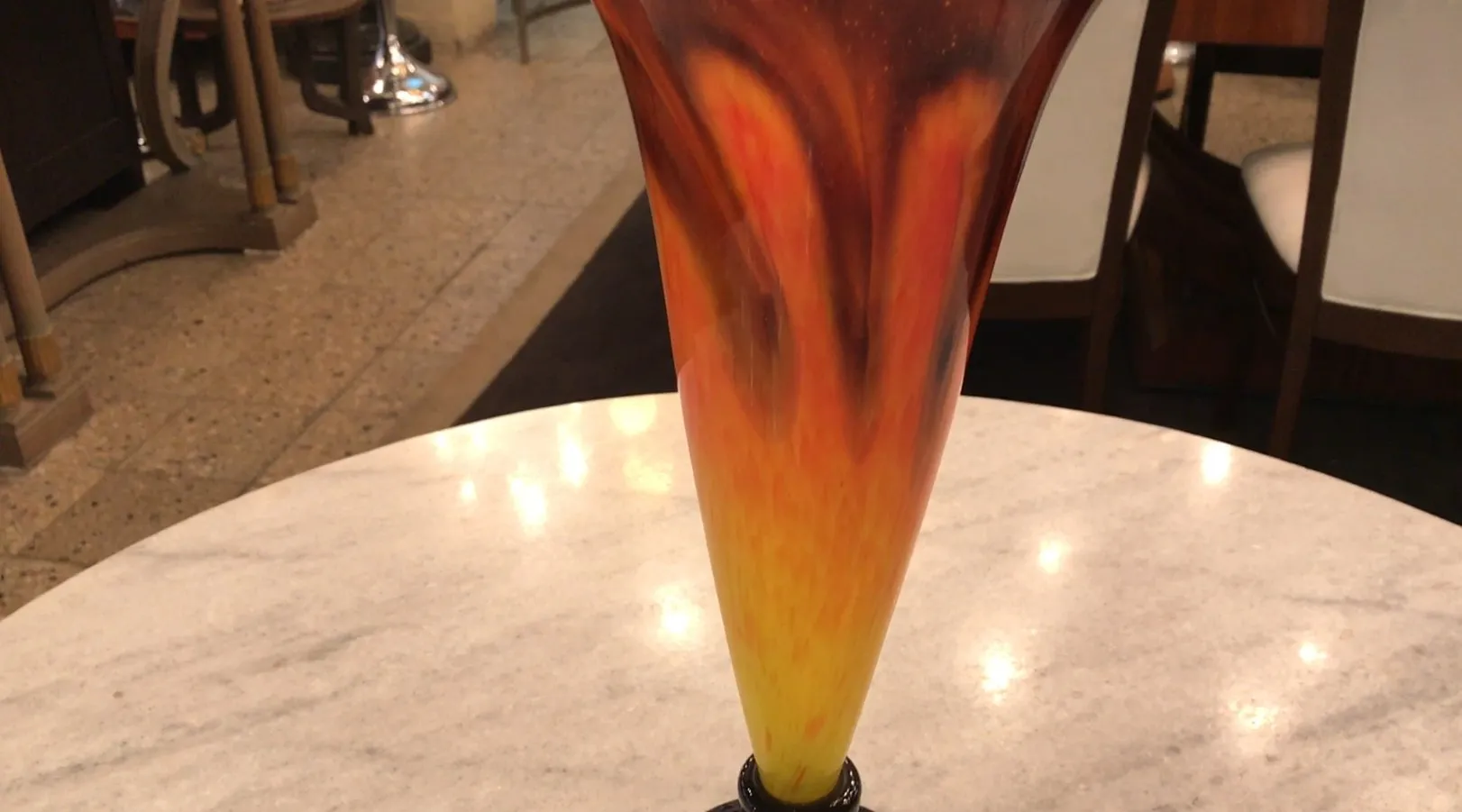 antique glass vase with signed detail, warm color gradients