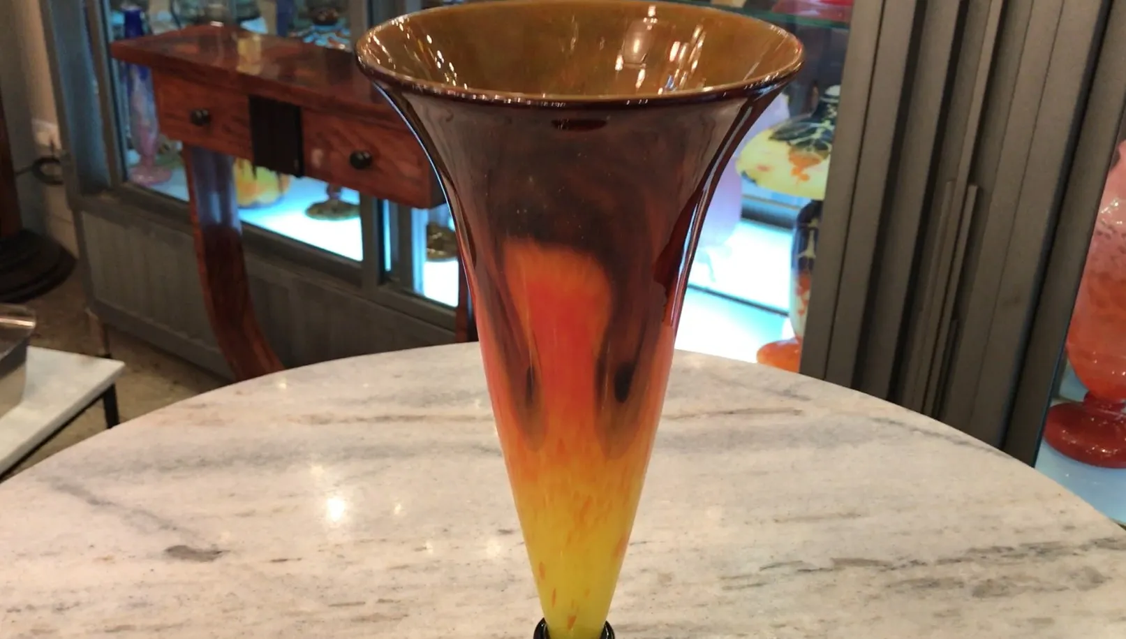 Vase ancien aux teintes ambre et jaune avec une base noire, décoratif.