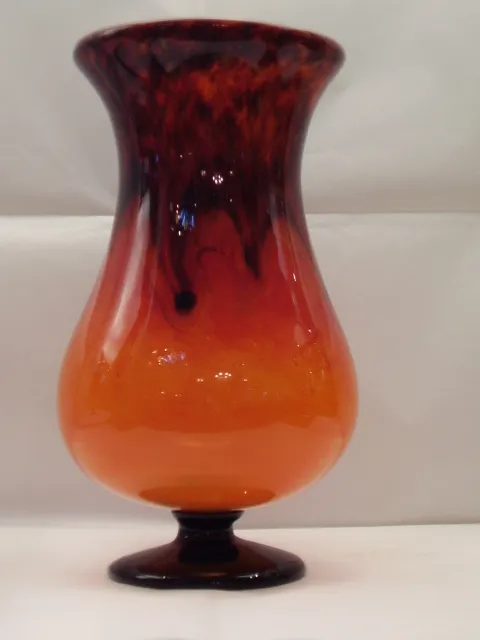 Antique signed glass in shades of orange and brown.