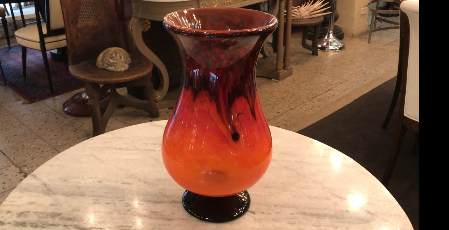 antique vase of signed glass by Schneider with vibrant colors, adorned with flowing shapes, in an elegant setting