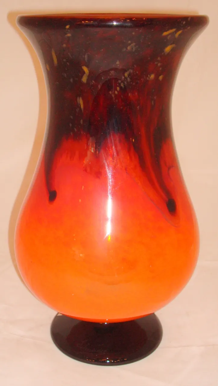 Vase made of glass with a gradient of red and orange, signature visible