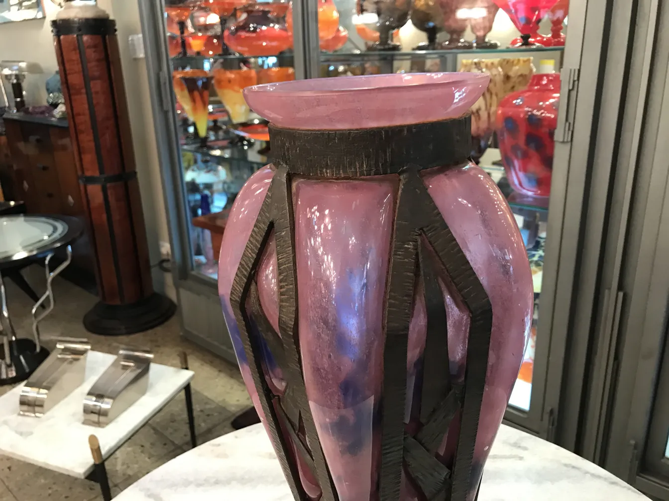 decorative glass vase signed by schneider in pink color in an antique setting
