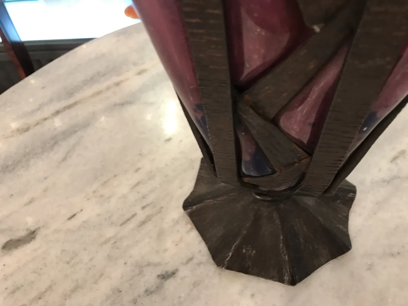 details of signed glass schneider in a decorative stand