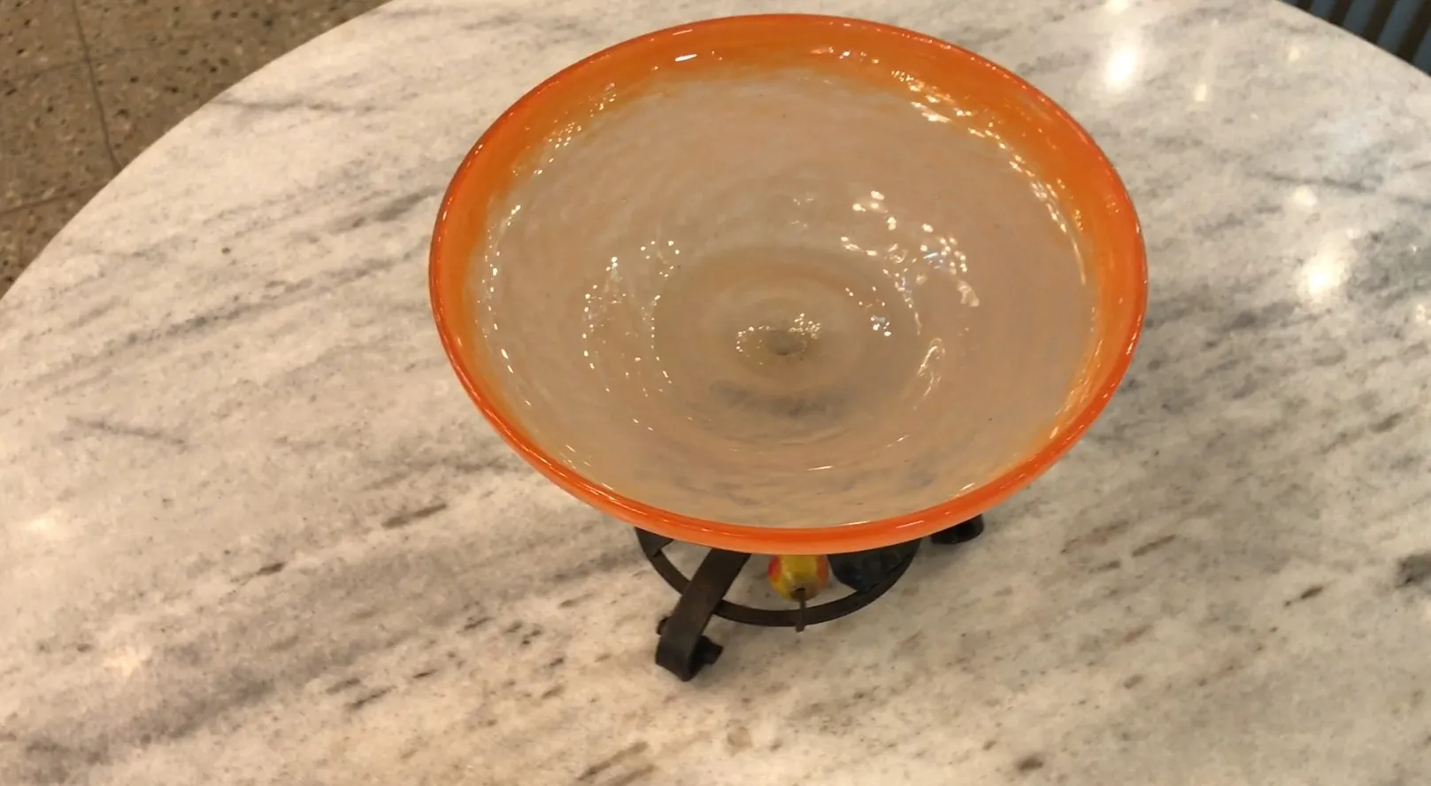 bowl of glass with orange rim and black base