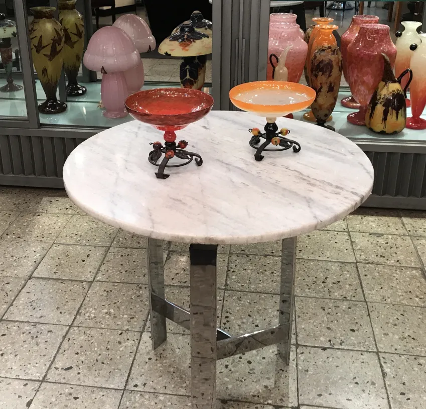 Antique setting with red and orange glass bowls, colorful display.