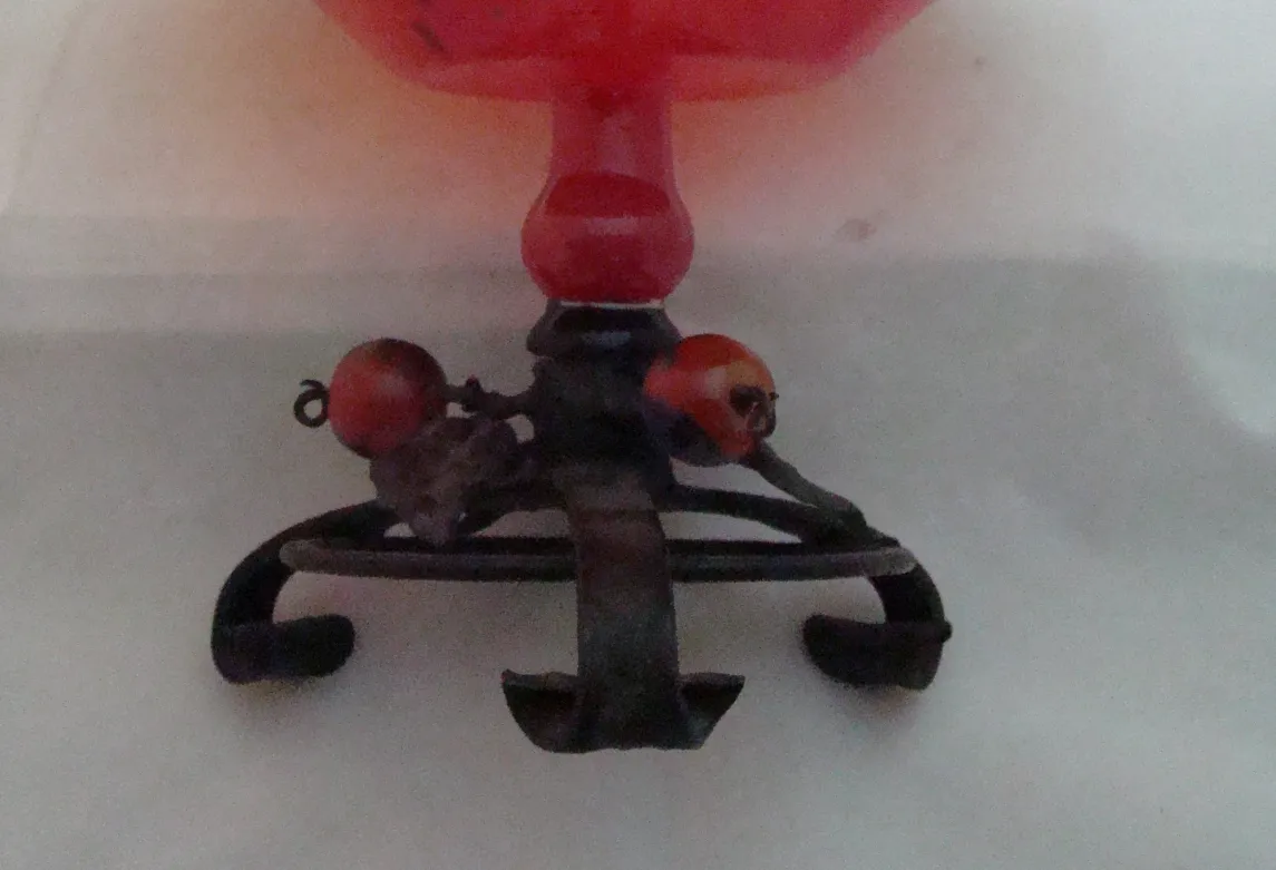 delicate glass with ornamental base and colored details