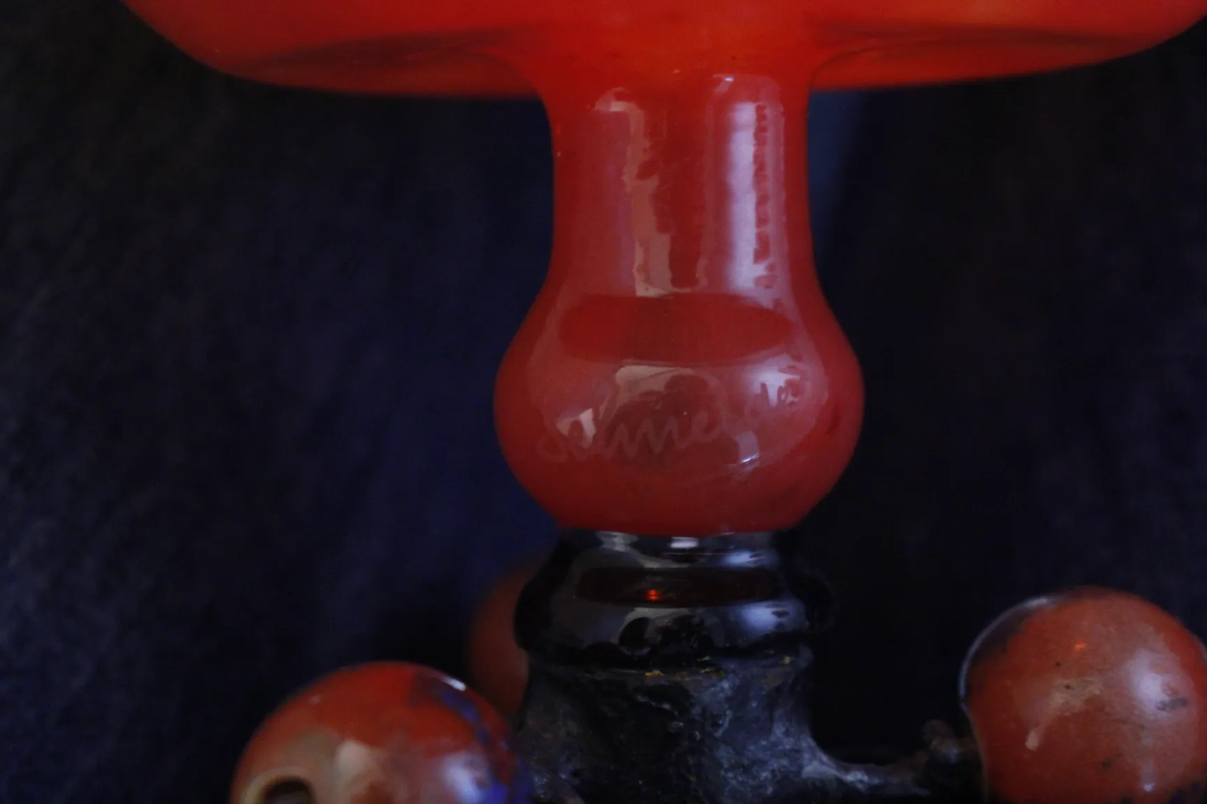 Antique signed glass in red with black base.