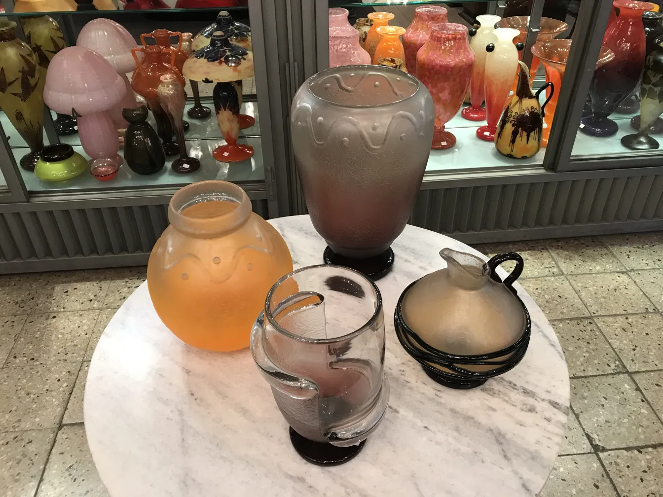 Antique signed glass by Schneider, decorative, colorful, surrounded by various antiques.