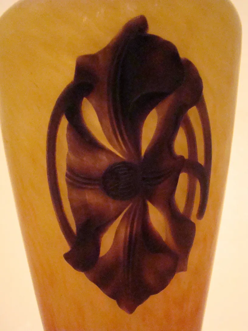 Antique glass with brown and yellow design, signature visible.