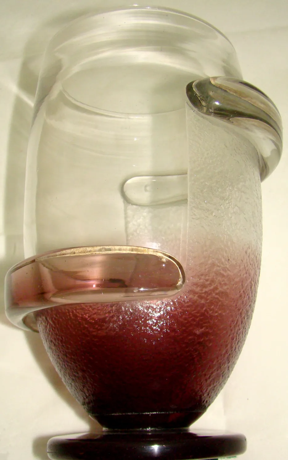 Clear glass with curves and colored base, signed