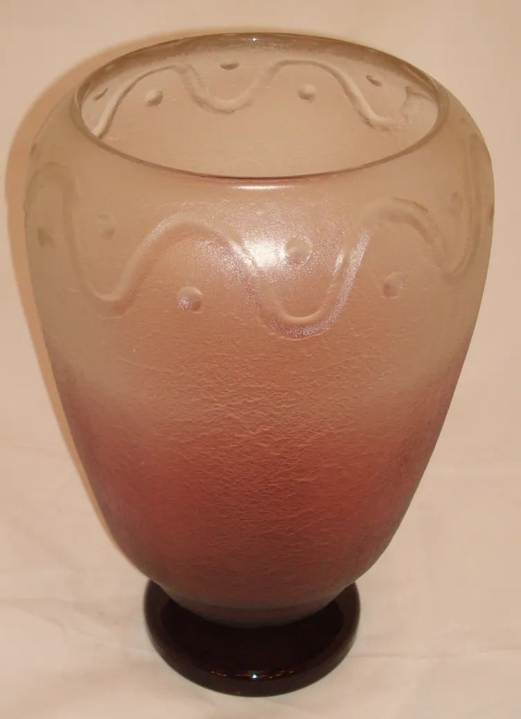 vase décoratif en verre avec signature, présentant des couleurs translucides et une base foncée