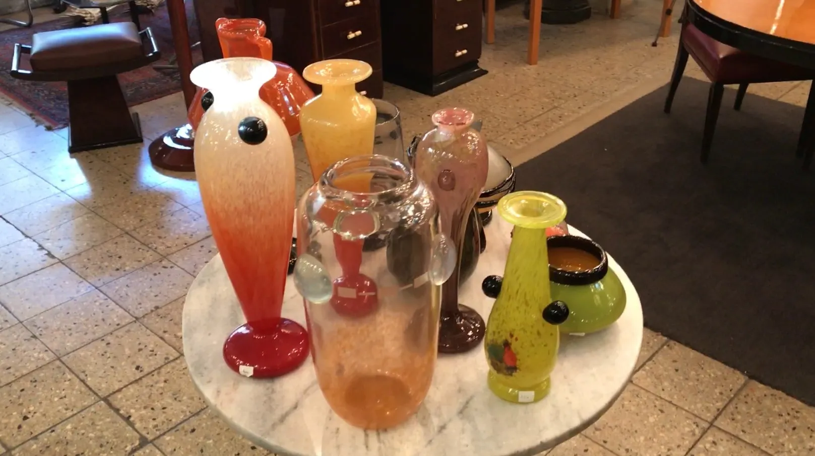 various glass vases around a signed schneider vase