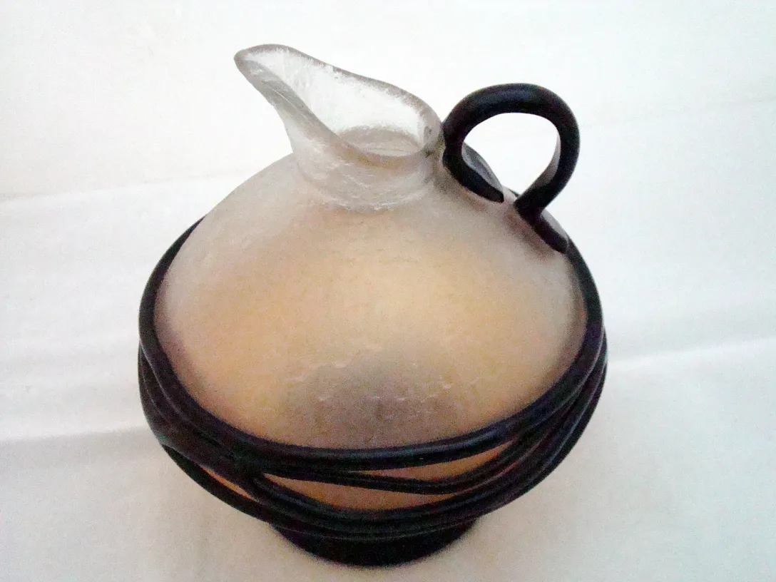 transparent glass with round shape and black base, antique