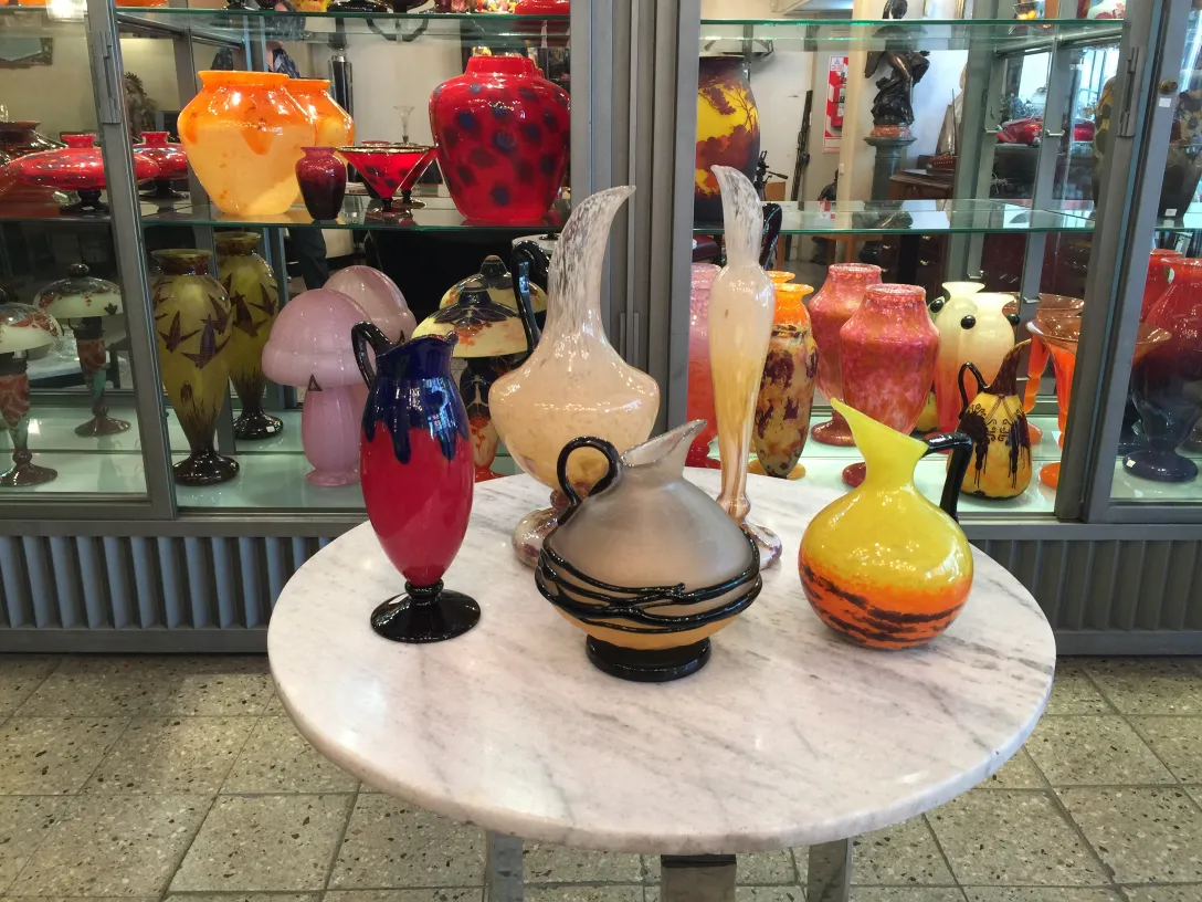 Collection of antiques with signed glass on display, vibrant colors.