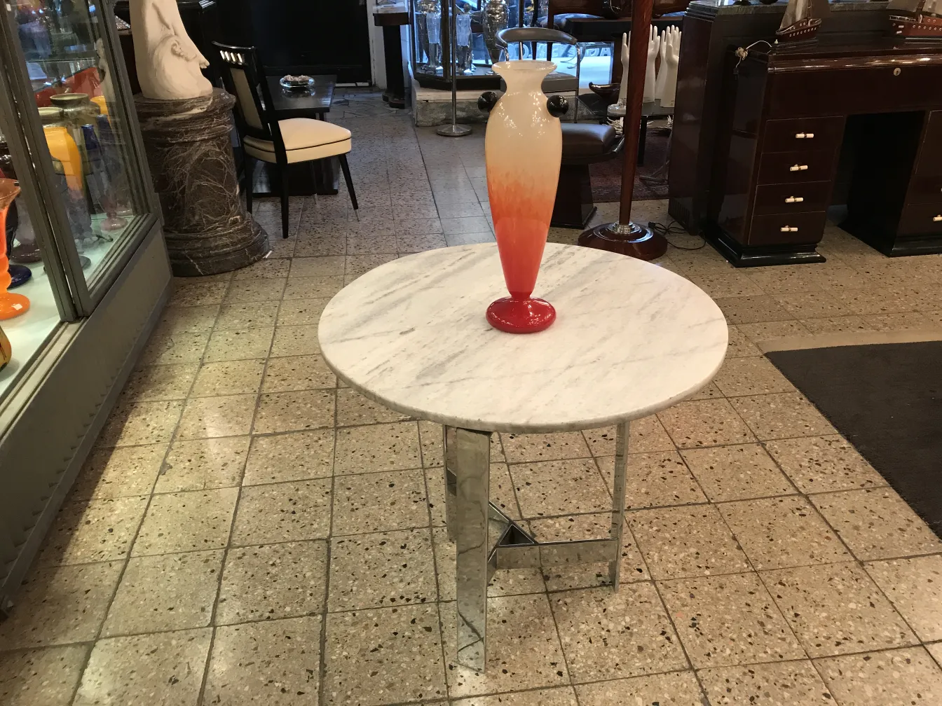 signed glass vase with orange gradient on a table