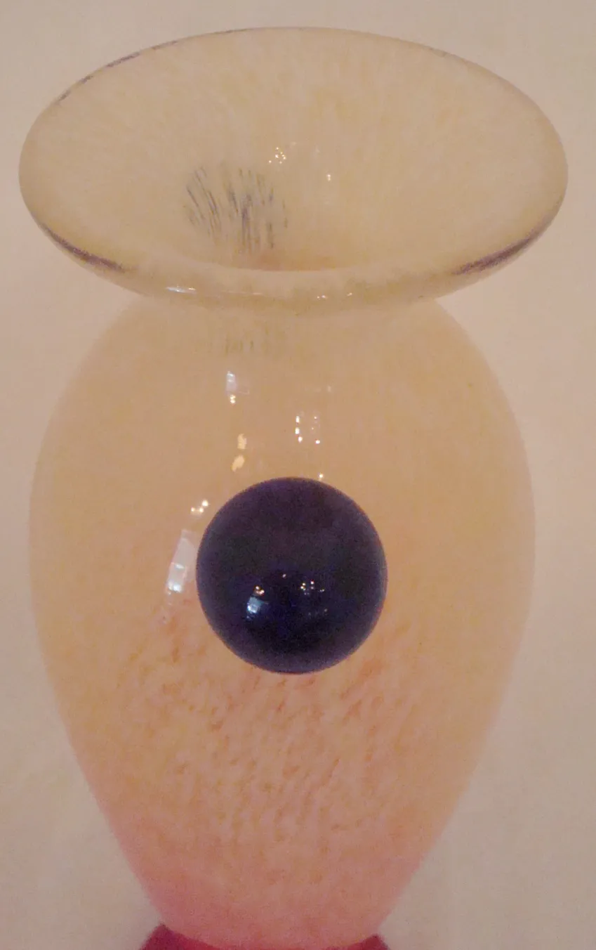 SIGNED GLASS Schneider with decorative design in soft tones, minimalistic background.