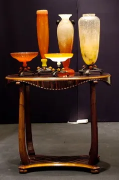 Antique glass vases in various colors on a table.