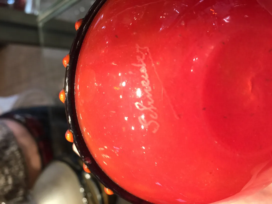 Ancient glass with Schneider signature at the bottom, vibrant decor.