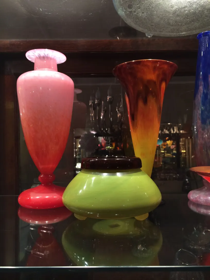 antique signed glass by Schneider on display, varied colors