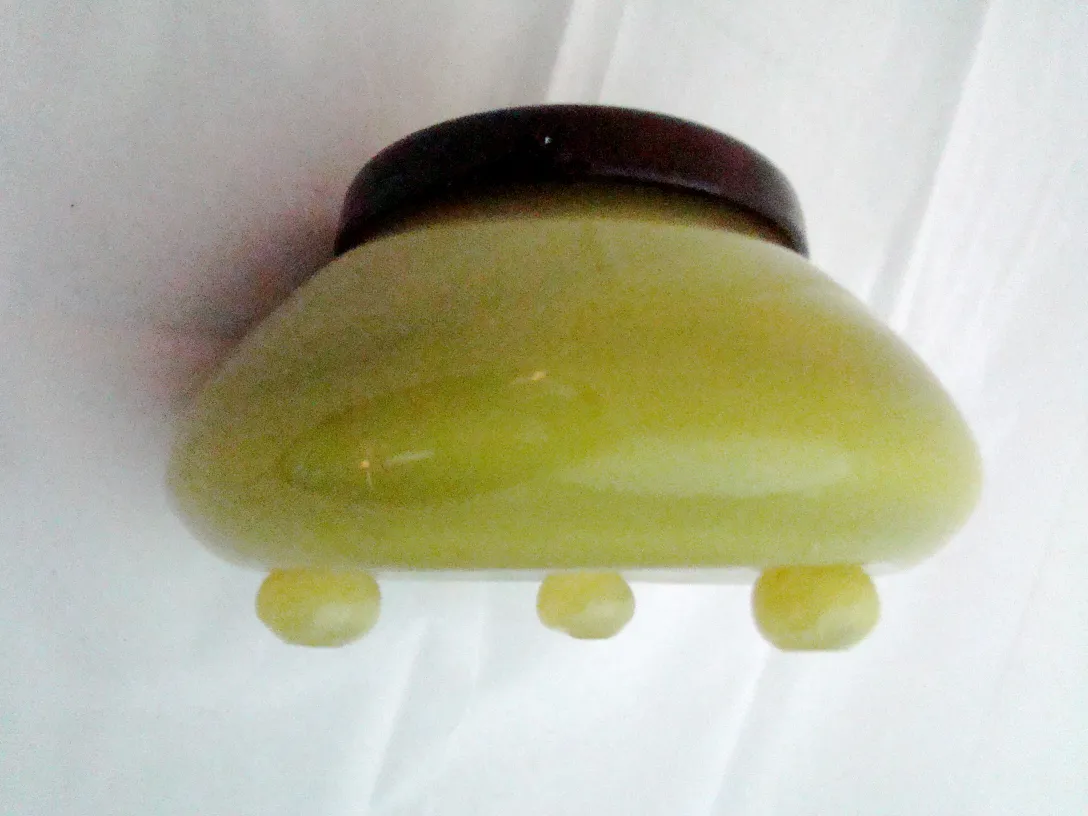 signed glass with rounded shape and stable base, in yellow