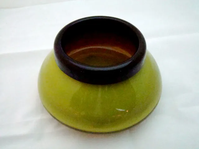 View of antique signed glass schneider in green color with detailing on the top.