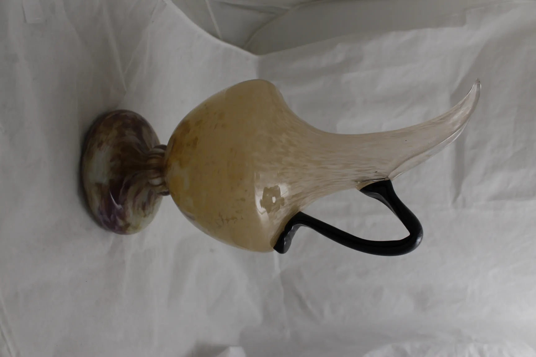 signed glass by Schneider with a wide body and black handle