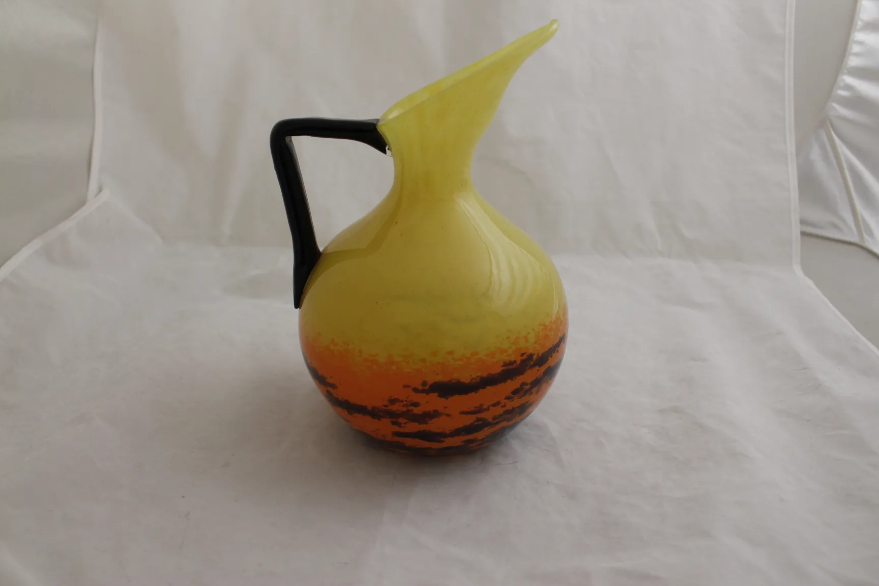 Antique stylish yellow and black glass jug.