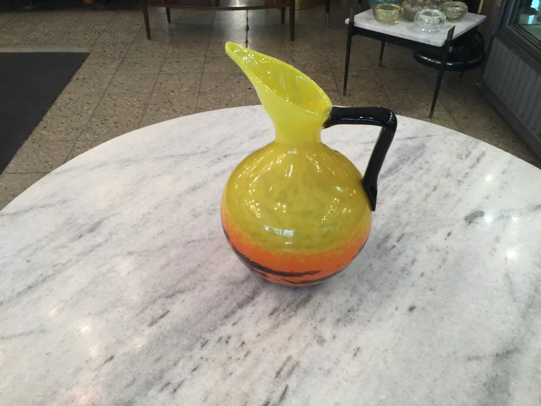 Colorful pitcher made of signed glass by Schneider on table
