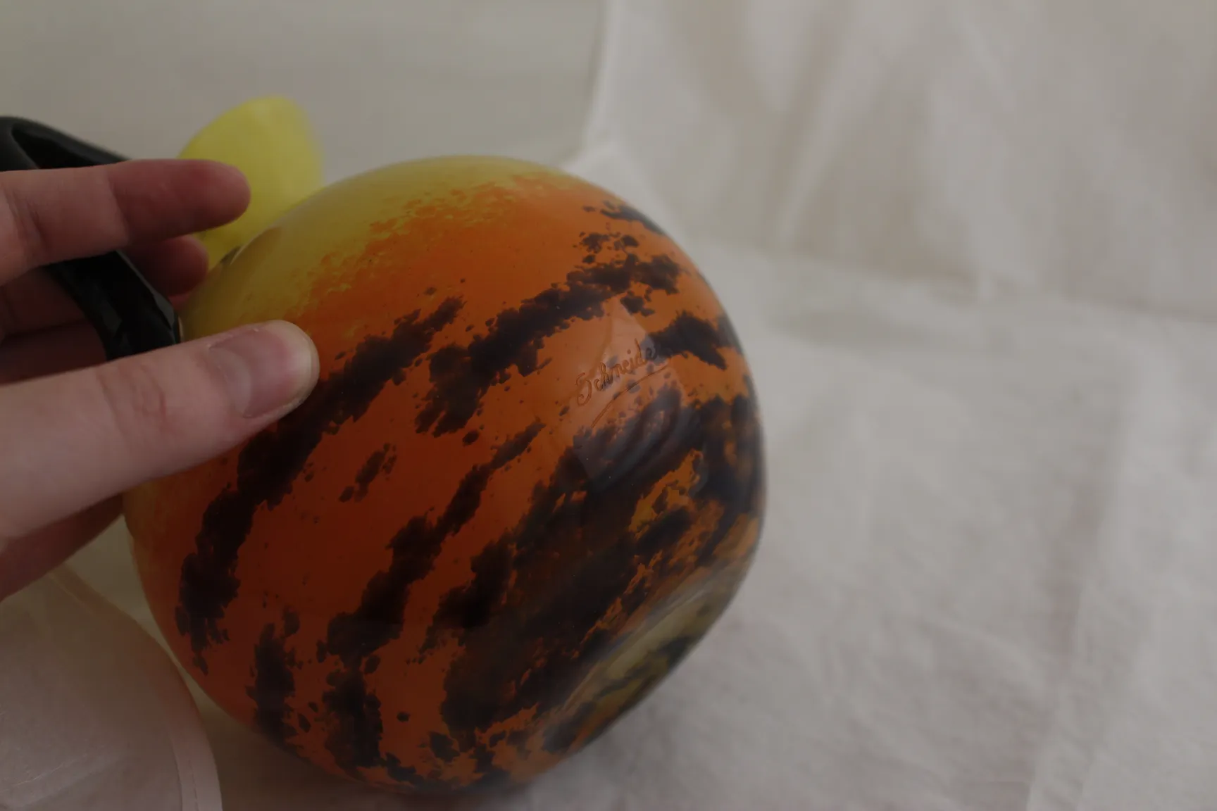 Round glass with orange and black colors, signed