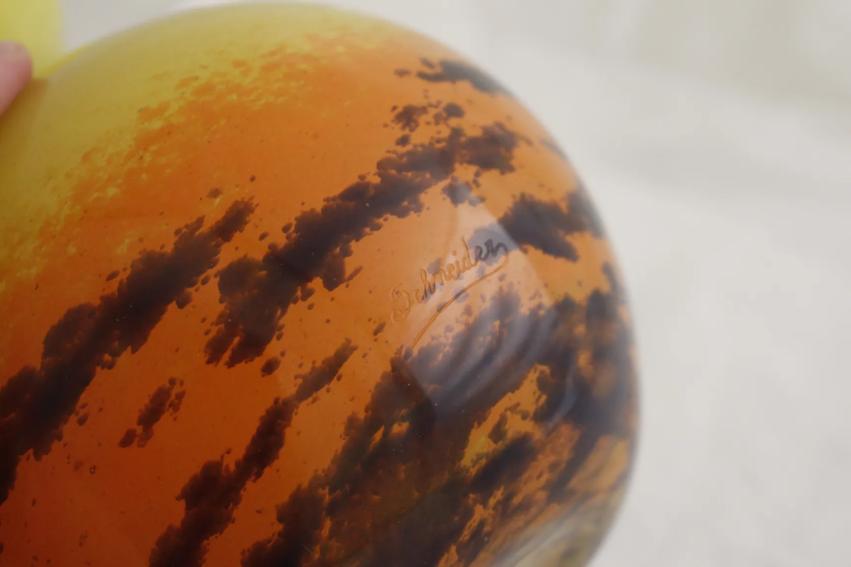 Antique glass with Schneider signature in warm hues.