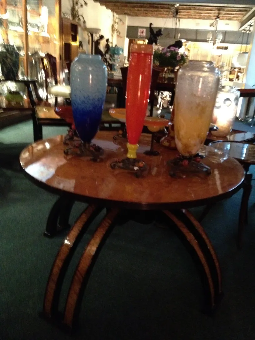 three decorative glass vases of different colors on a table