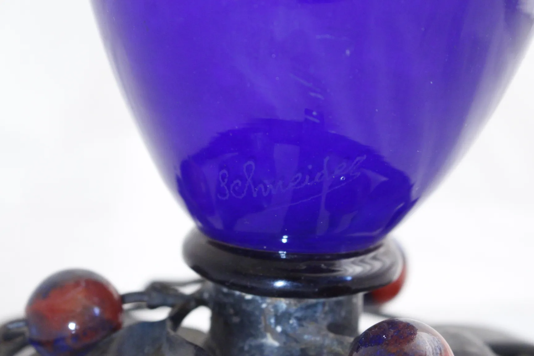 antique glass with Schneider signature, blue and black design.