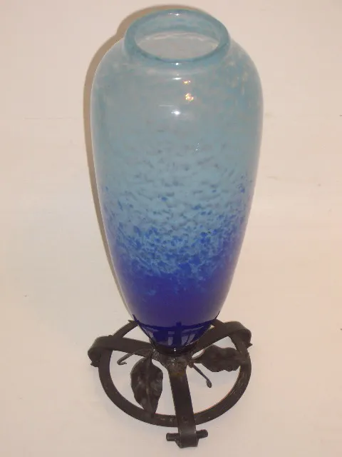 Antique glass vase in blue and light shades with decorative stand.
