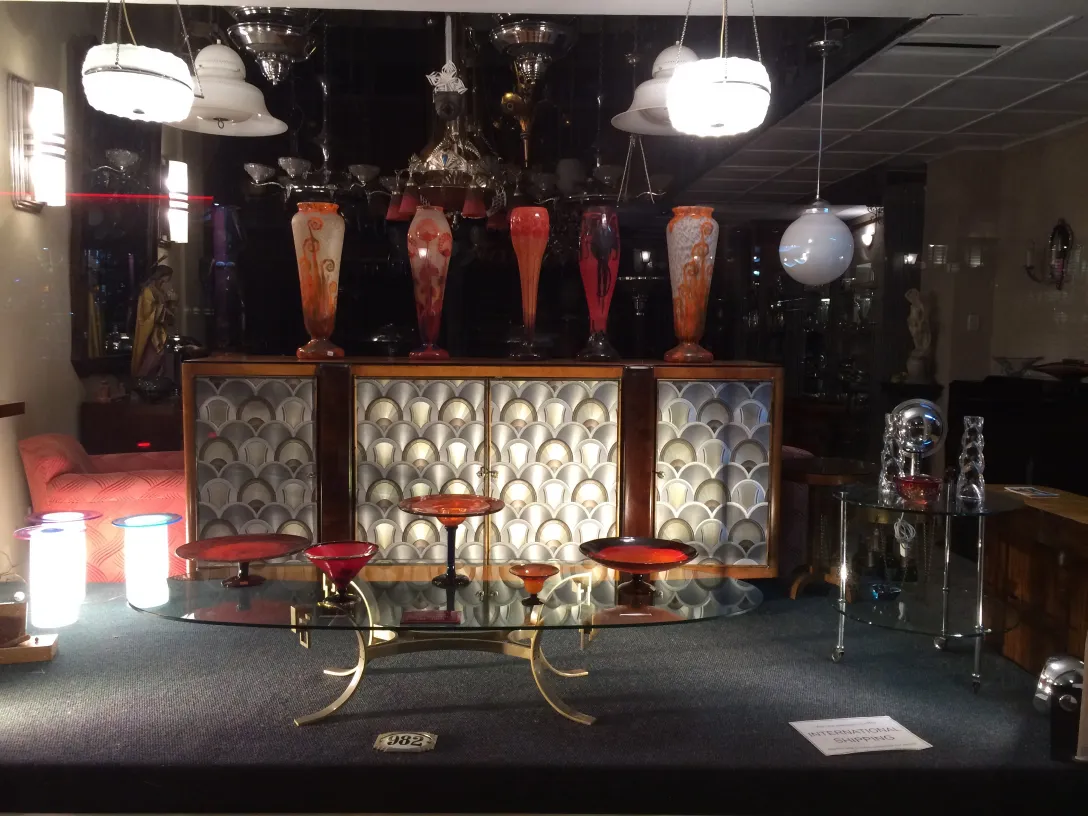 signed glass in a display with other antique items