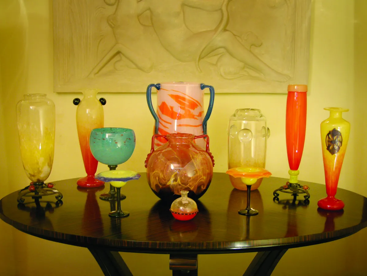 signed glass piece in an antique setting with vibrant colors