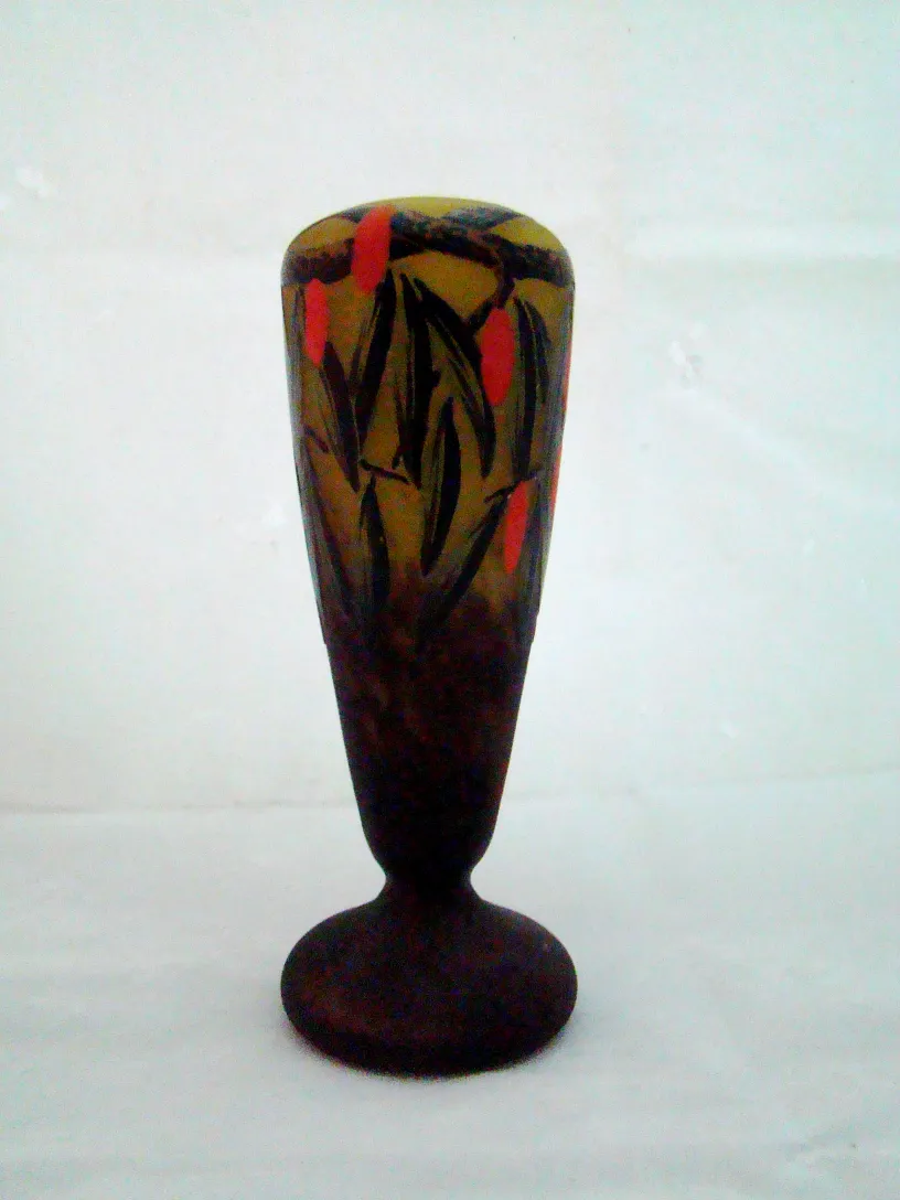 Antique vase with floral design in yellow and red hues.