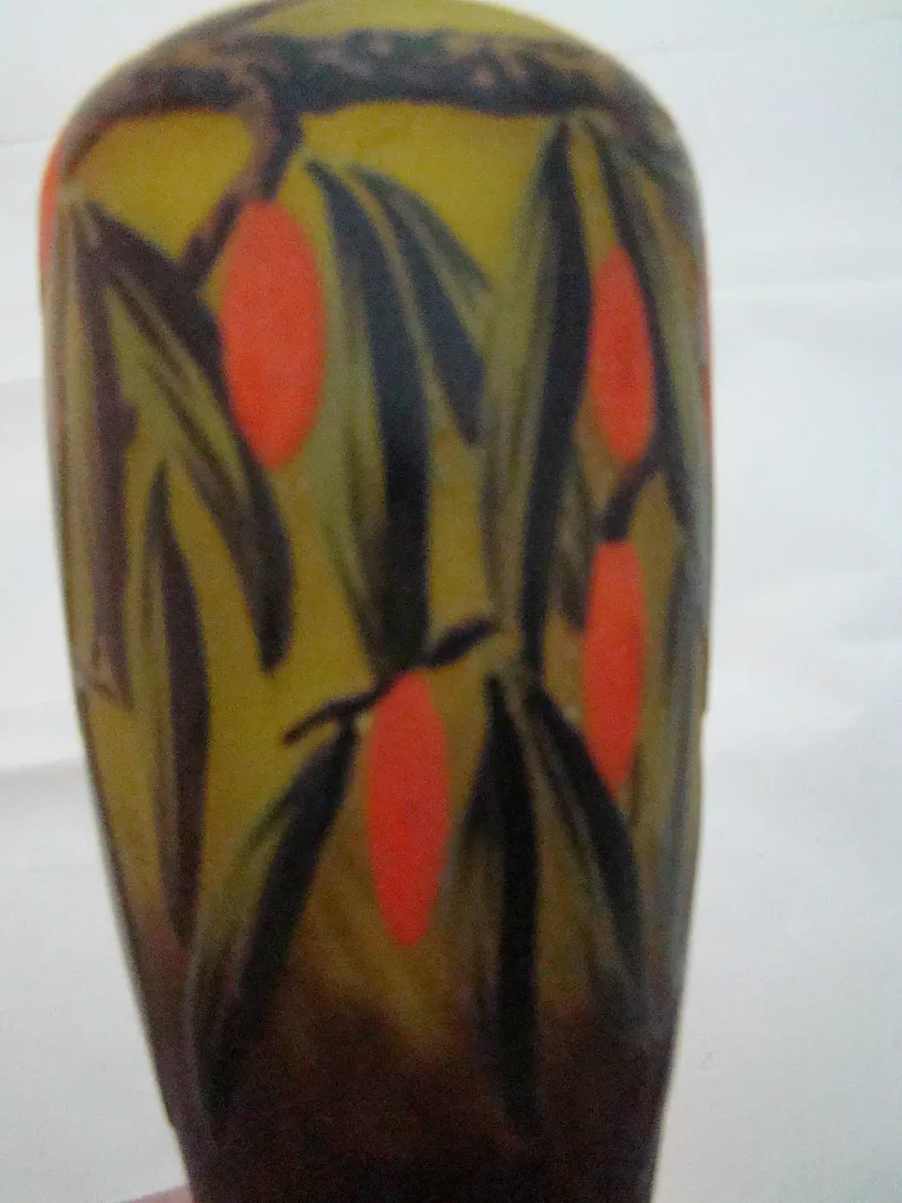 Antique signed glass by Schneider featuring orange and green decorations.