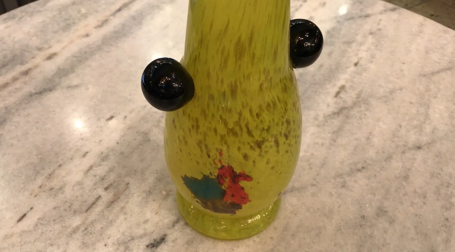 Verre antique jaune avec des détails de signature dans un cadre élégant.