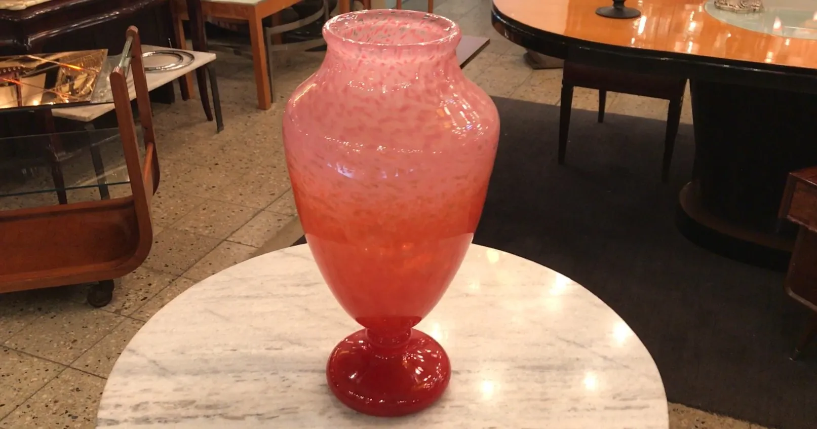 antique signed glass vase by Schneider, elegantly shaped with vibrant colors, in a cozy setting