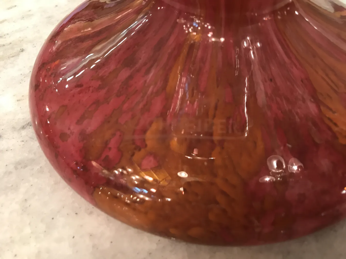 Antique glass featuring Schneider's signature in red and brown.