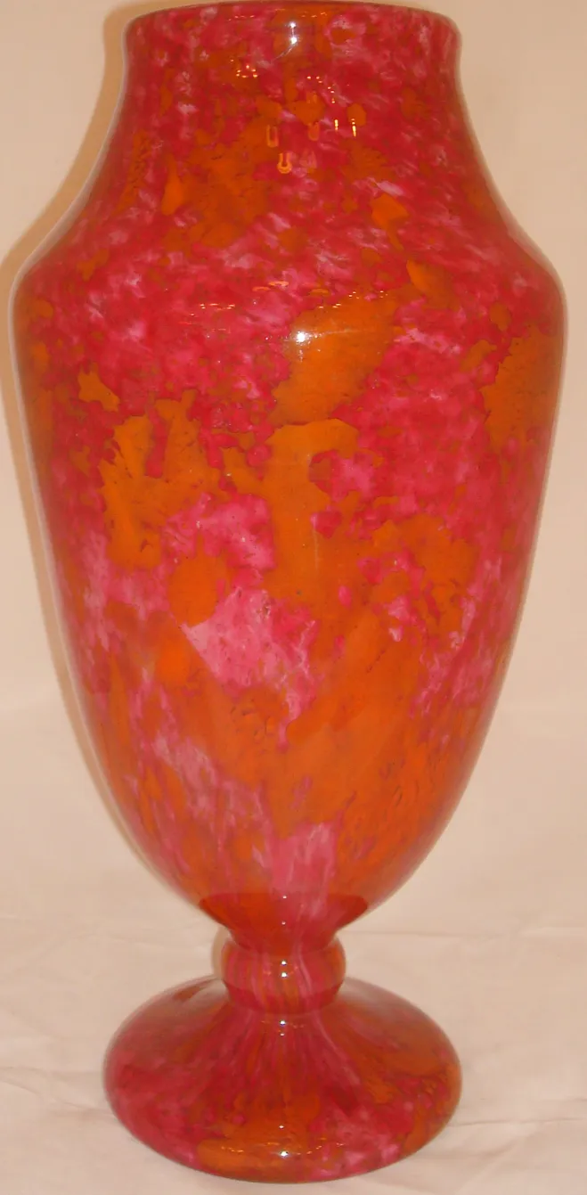 signed glass in pink and orange hues with a stylish base