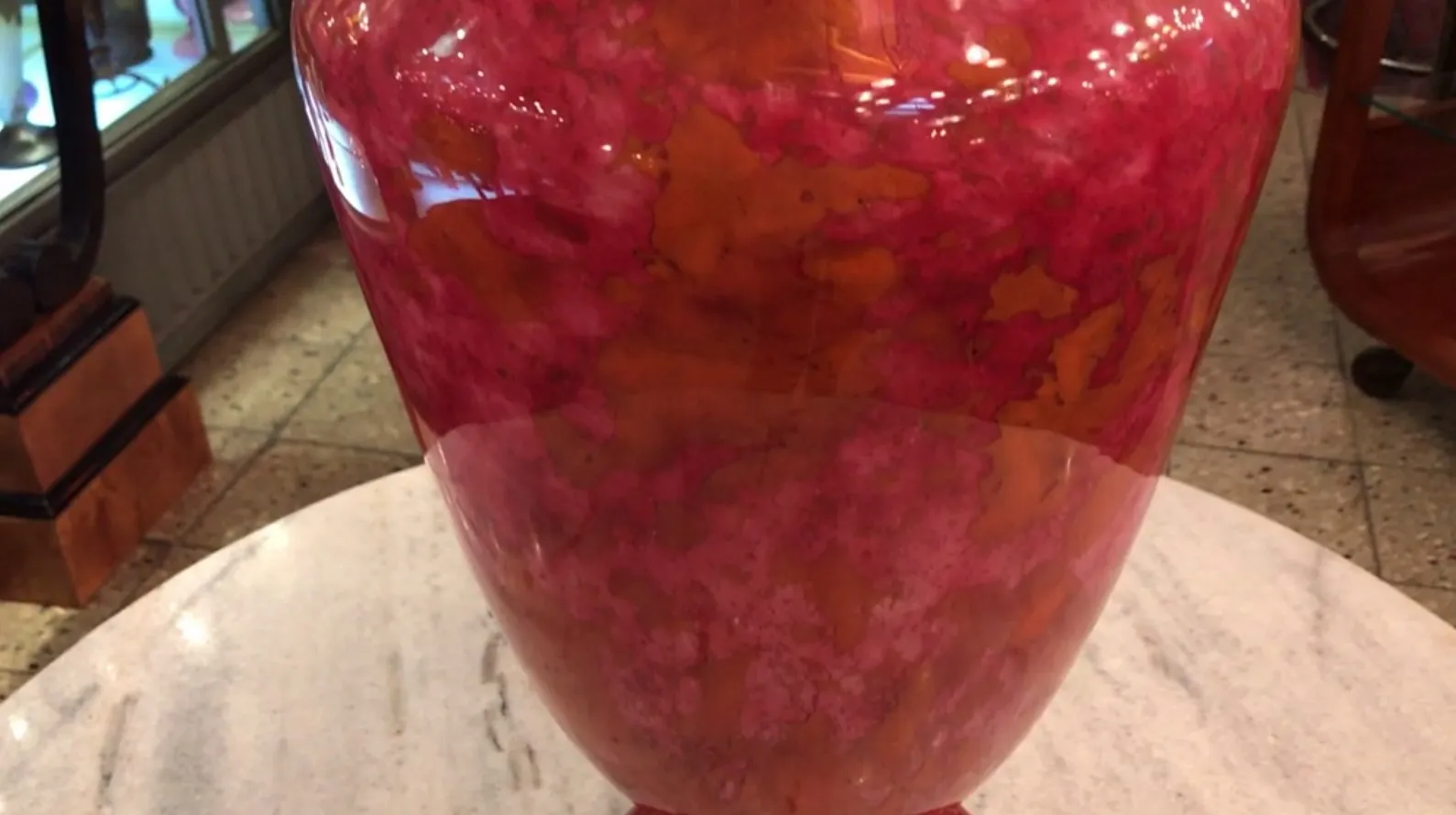 Antique vase in warm tones featuring a signature on top.