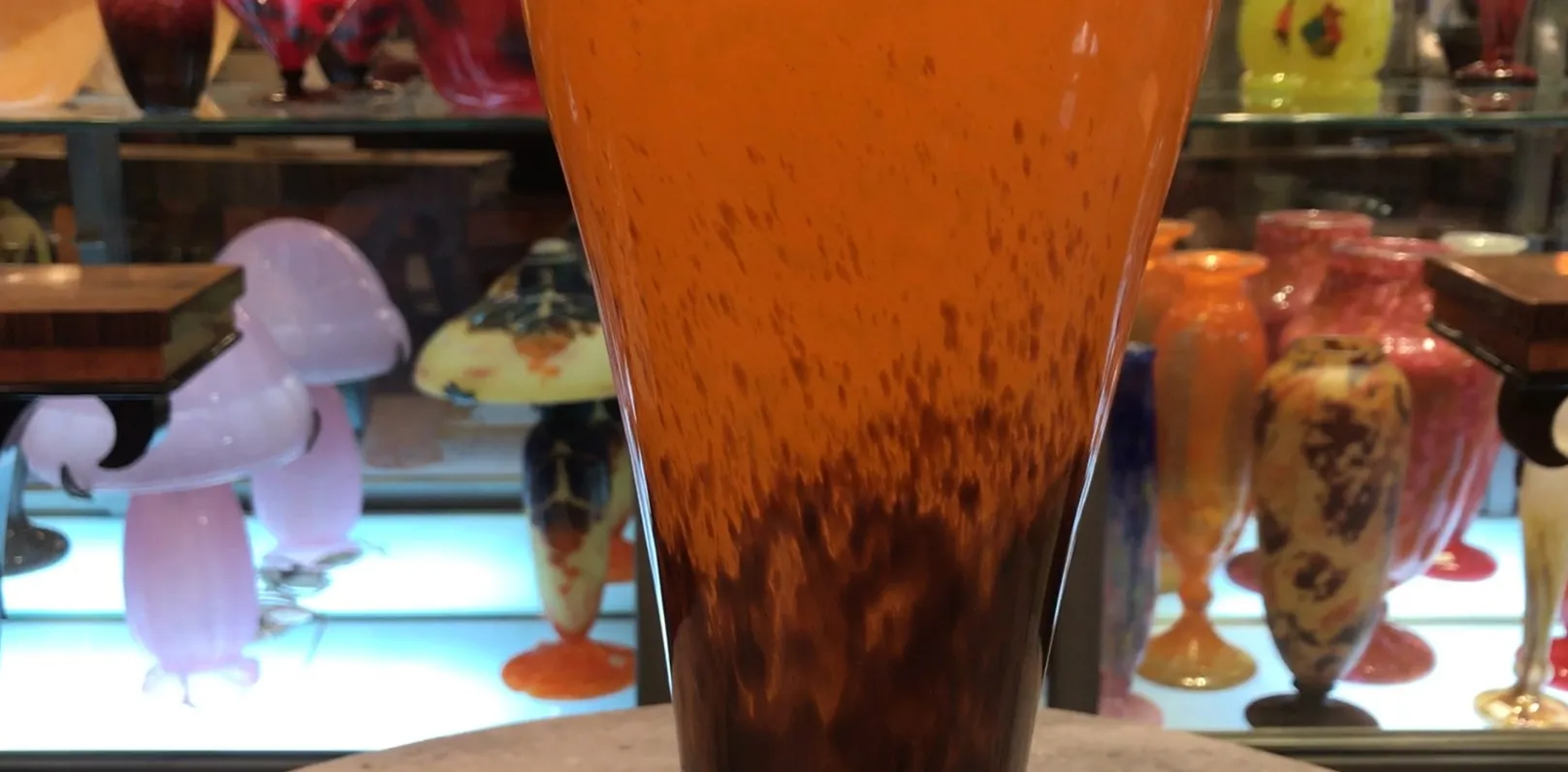 antique glass with signature at the bottom, orange and brown color