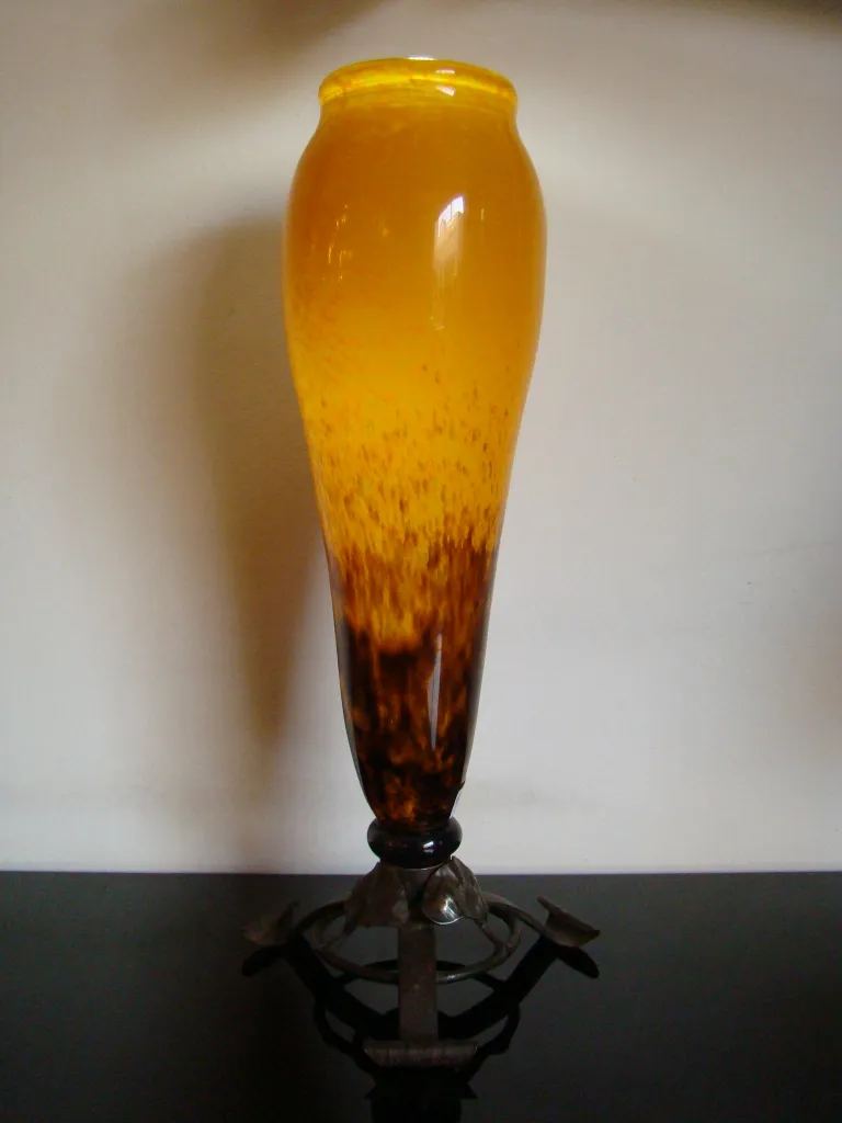 detail of an antique signed glass by Schneider, featuring amber tones