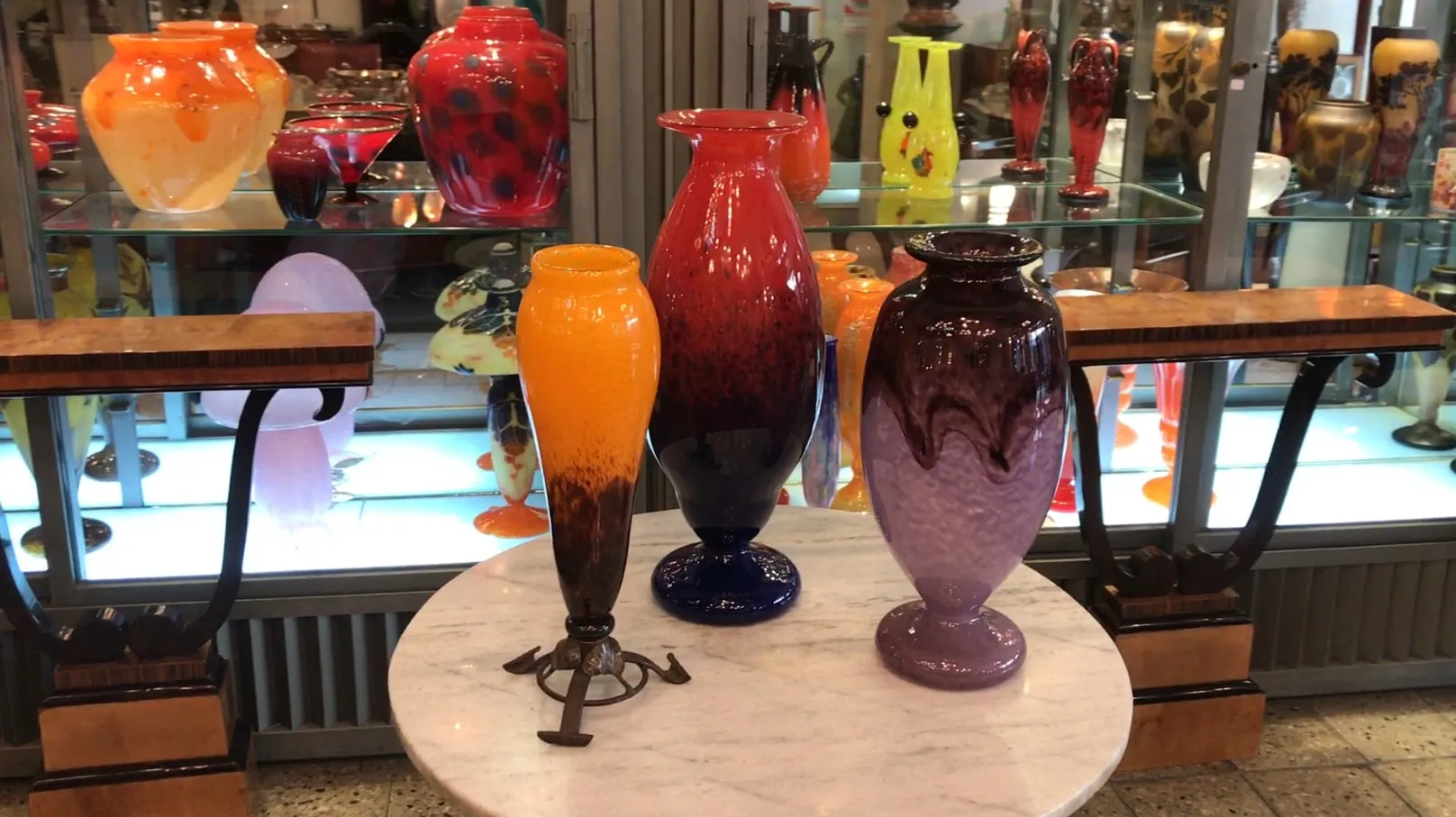Elegant signed glass Schneider in vibrant colors on display.