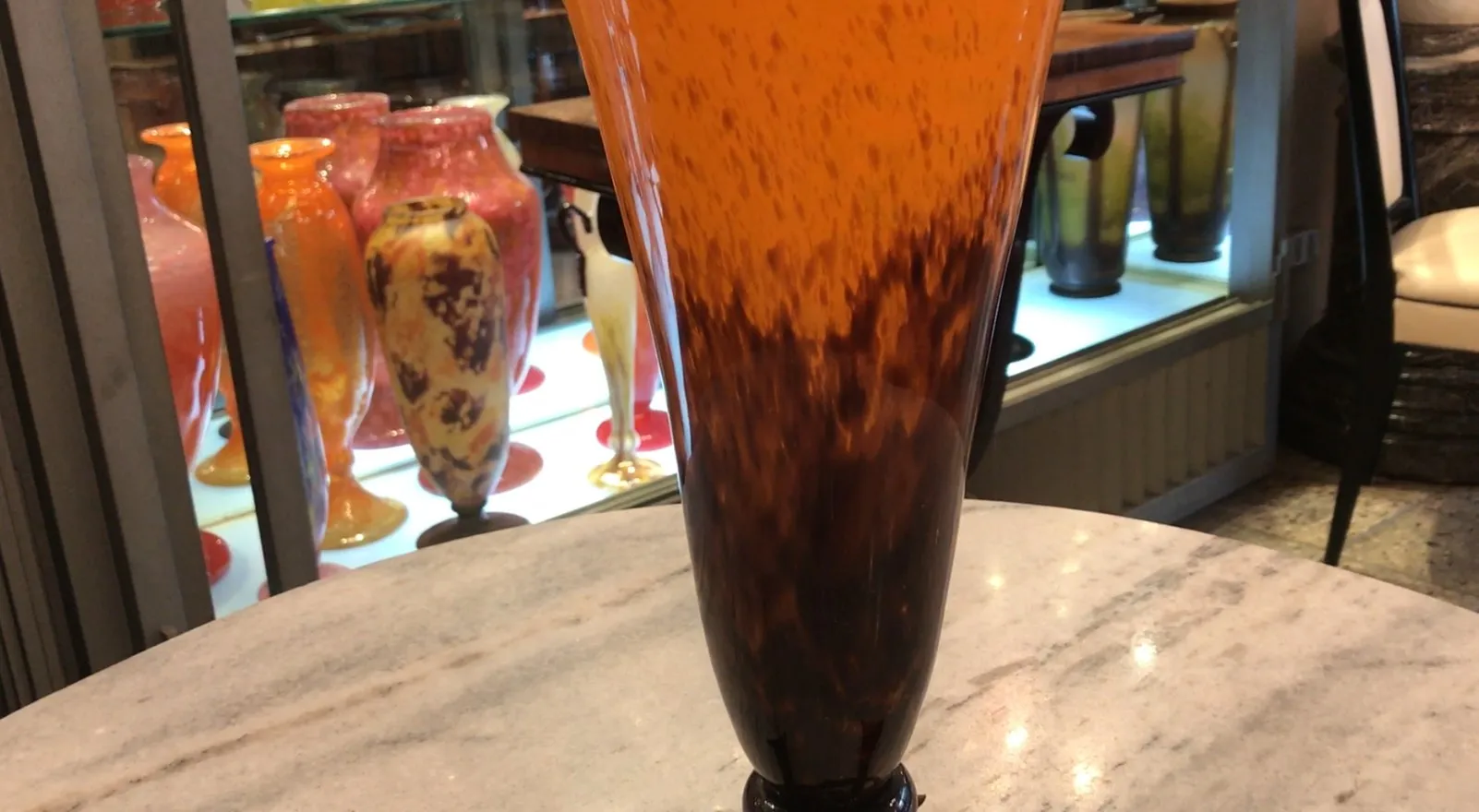 Amber signed glass with dark base, part of an antique collection.