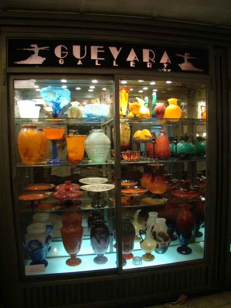 signed glass with vibrant colors displayed in lit showcase