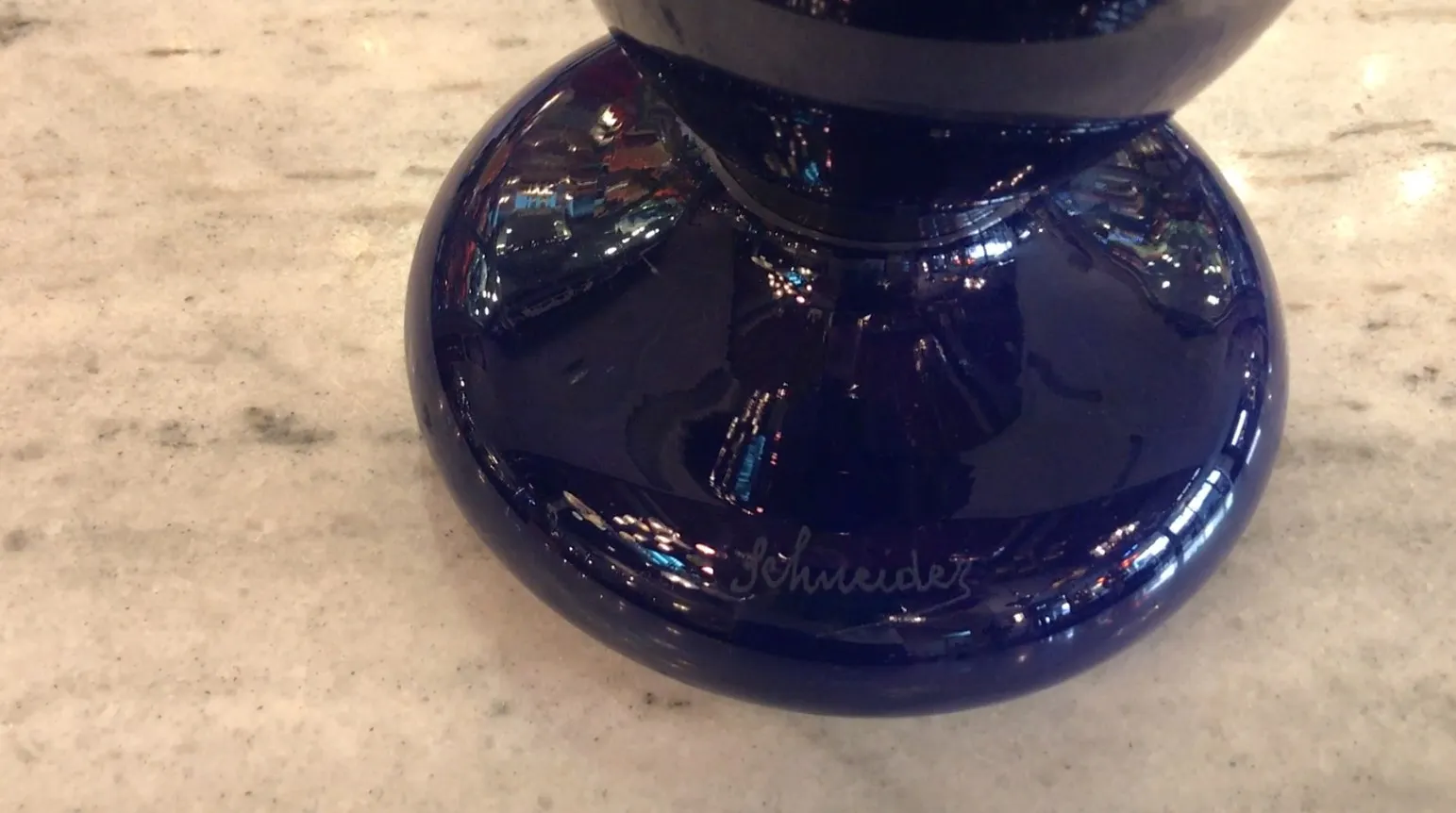 dark blue signed glass with a reflective background