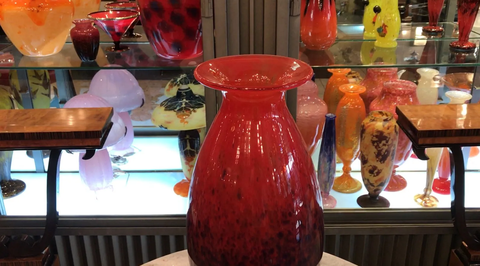 red vase of signed glass by Schneider on display